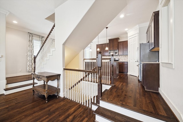interior space featuring baseboards, wood finished floors, and a wealth of natural light