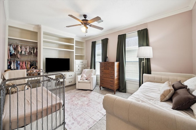 bedroom featuring light colored carpet, a ceiling fan, ornamental molding, and a closet