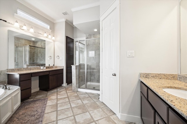 full bath featuring two vanities, a shower stall, a sink, baseboards, and crown molding