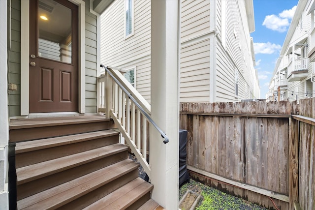 view of exterior entry featuring fence