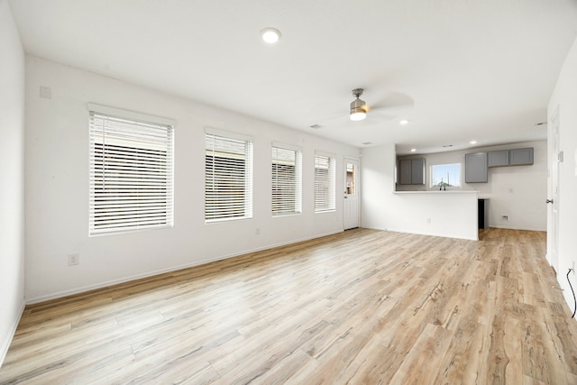 unfurnished living room featuring recessed lighting, light wood-type flooring, baseboards, and ceiling fan