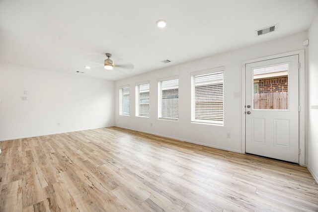 interior space featuring a ceiling fan, visible vents, recessed lighting, and light wood-style floors