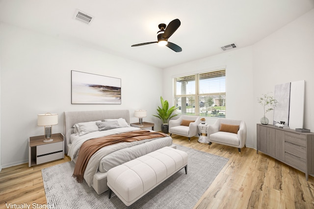 bedroom with a ceiling fan, visible vents, and light wood-style flooring
