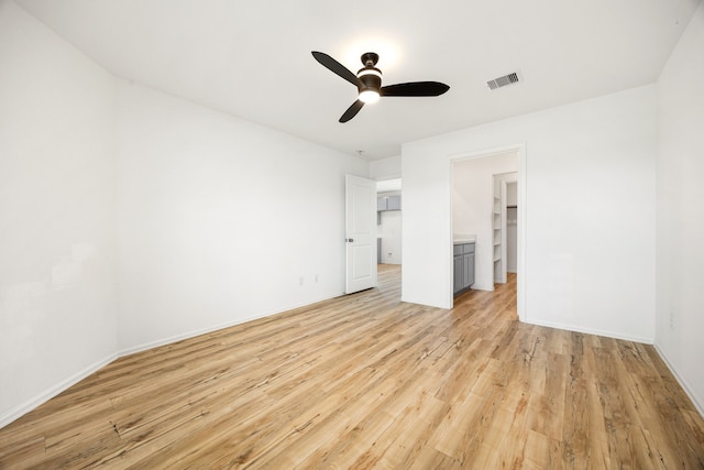 unfurnished bedroom featuring baseboards, visible vents, light wood-style floors, and ceiling fan