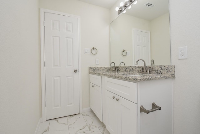 bathroom featuring baseboards, visible vents, a sink, and marble finish floor
