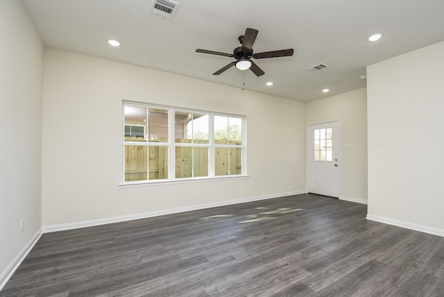 spare room featuring visible vents, recessed lighting, dark wood-style floors, and ceiling fan