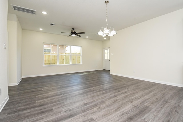 empty room with recessed lighting, dark wood finished floors, visible vents, and ceiling fan with notable chandelier