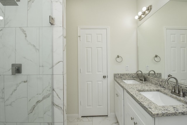 full bathroom with double vanity, marble finish floor, a sink, and a marble finish shower