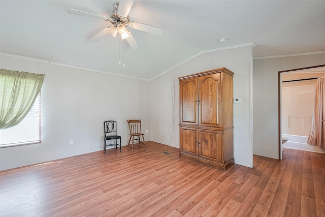 living area featuring crown molding, ceiling fan, light wood finished floors, lofted ceiling, and visible vents