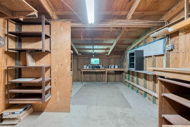 unfinished basement featuring a workshop area