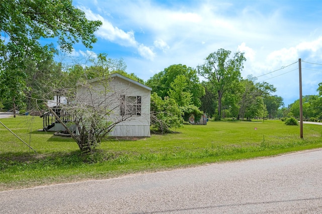 view of home's exterior with a lawn