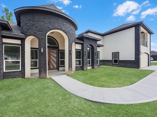 549 Rd 660, Dayton, TX 77535 - view of front of house with stucco siding, a front lawn, stone siding, and an attached garage