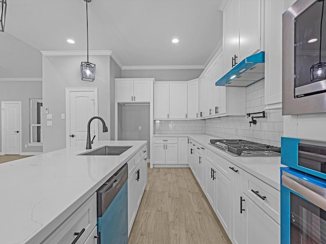 549 Rd 660, Dayton, TX 77535 - kitchen featuring a sink, white cabinetry, appliances with stainless steel finishes, under cabinet range hood, and ornamental molding