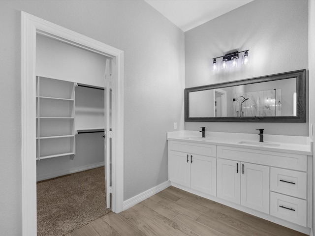 549 Rd 660, Dayton, TX 77535 - bathroom with a shower stall, wood finished floors, a sink, and double vanity