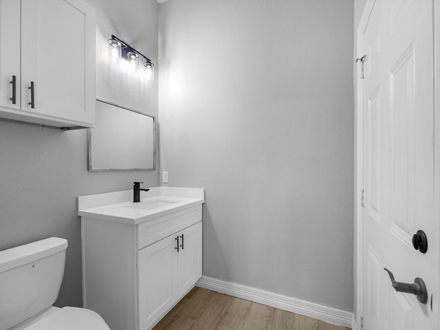549 Rd 660, Dayton, TX 77535 - half bath featuring toilet, vanity, wood finished floors, and baseboards