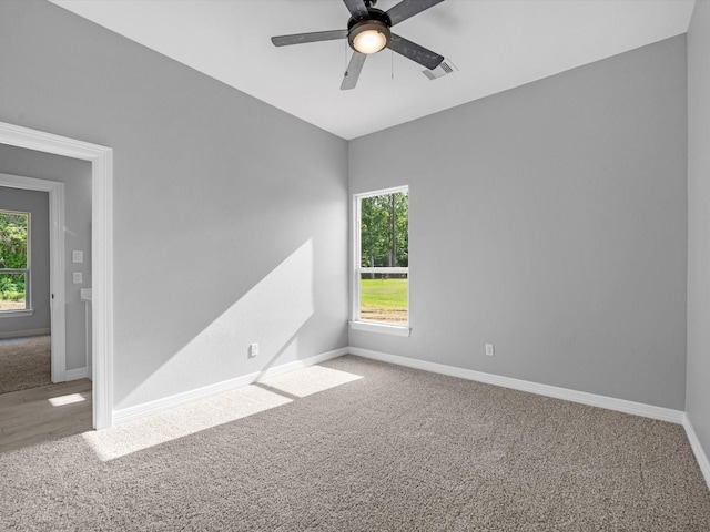 549 Rd 660, Dayton, TX 77535 - carpeted empty room with a healthy amount of sunlight, baseboards, ceiling fan, and visible vents