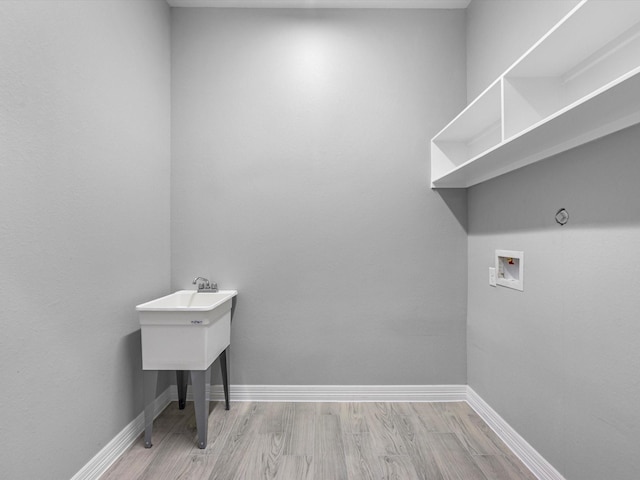 549 Rd 660, Dayton, TX 77535 - washroom featuring baseboards, light wood-style floors, laundry area, and washer hookup