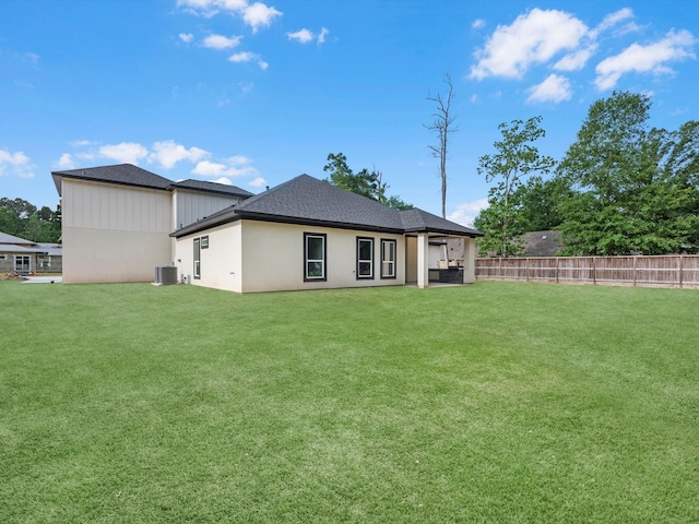 549 Rd 660, Dayton, TX 77535 - back of property with a lawn, central AC unit, fence, and roof with shingles