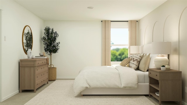 bedroom with baseboards and light colored carpet