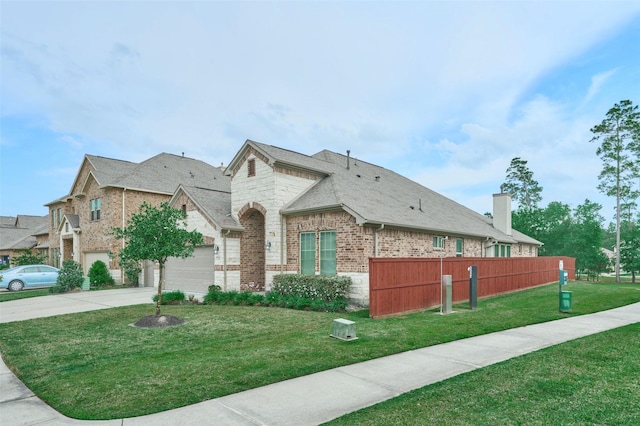 view of property exterior with concrete driveway, a chimney, fence, a yard, and brick siding