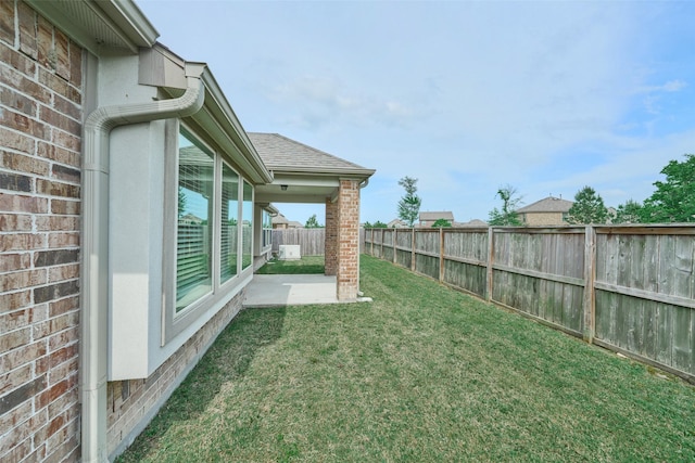 view of yard featuring a patio area and a fenced backyard
