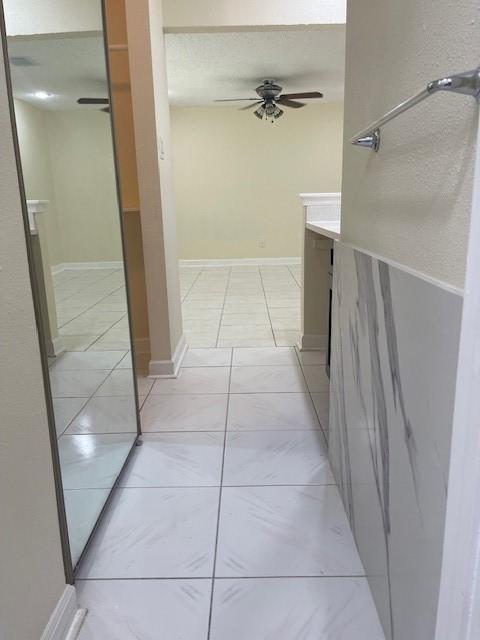 11411 Meadow Joy Dr, Houston, TX 77089 - hallway with baseboards and light tile patterned floors