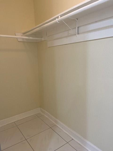 11411 Meadow Joy Dr, Houston, TX 77089 - walk in closet with light tile patterned floors