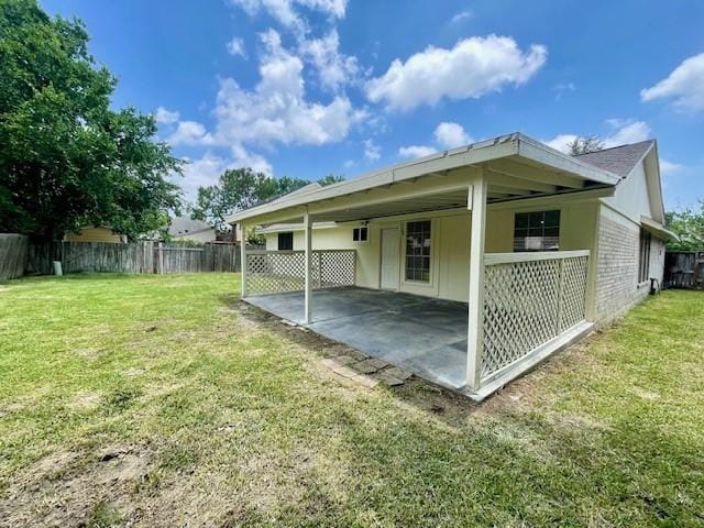 11411 Meadow Joy Dr, Houston, TX 77089 - rear view of house with fence, a patio area, a lawn, and brick siding