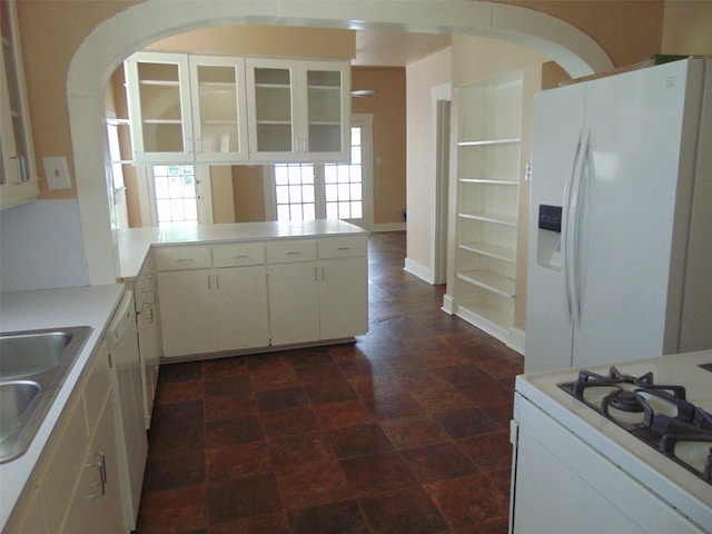 4620 Oak Ridge St, Houston, TX 77009 - kitchen with a peninsula, white appliances, glass insert cabinets, light countertops, and white cabinets