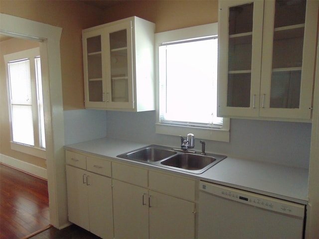 4620 Oak Ridge St, Houston, TX 77009 - kitchen with white dishwasher, light countertops, a sink, and glass insert cabinets