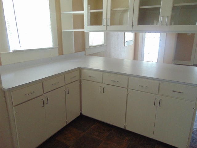 4620 Oak Ridge St, Houston, TX 77009 - kitchen featuring white cabinets, open shelves, glass insert cabinets, and light countertops