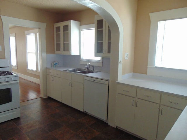 4620 Oak Ridge St, Houston, TX 77009 - kitchen with white appliances, glass insert cabinets, a sink, and light countertops