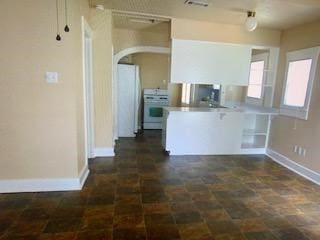 4620 Oak Ridge St, Houston, TX 77009 - kitchen featuring arched walkways, stove, stone finish floor, baseboards, and visible vents