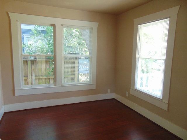 4620 Oak Ridge St, Houston, TX 77009 - empty room with baseboards, dark wood finished floors, and a wealth of natural light