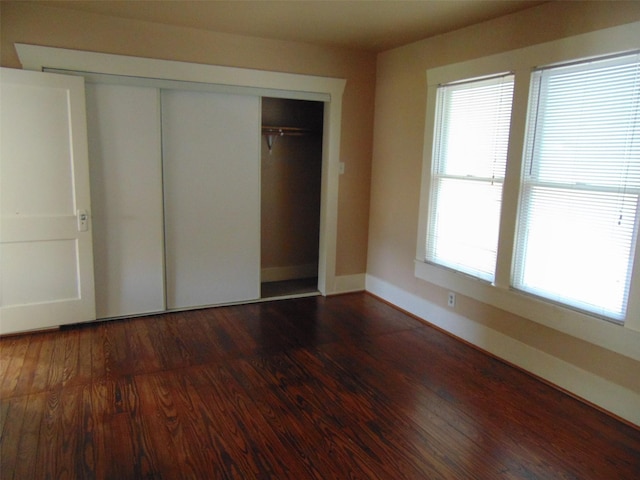 4620 Oak Ridge St, Houston, TX 77009 - unfurnished bedroom featuring a closet, baseboards, and wood finished floors