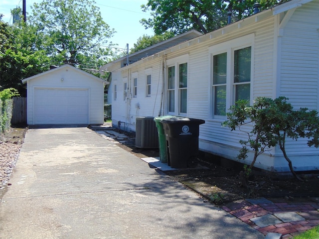 4620 Oak Ridge St, Houston, TX 77009 - view of home's exterior featuring a detached garage, driveway, an outdoor structure, and cooling unit