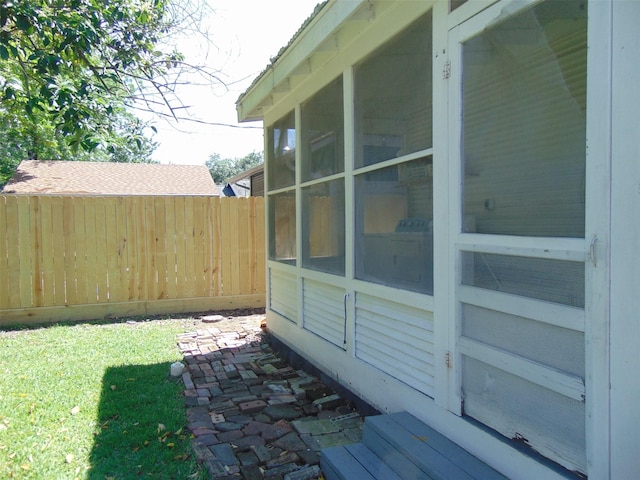 4620 Oak Ridge St, Houston, TX 77009 - view of side of home with fence, a lawn, and a sunroom