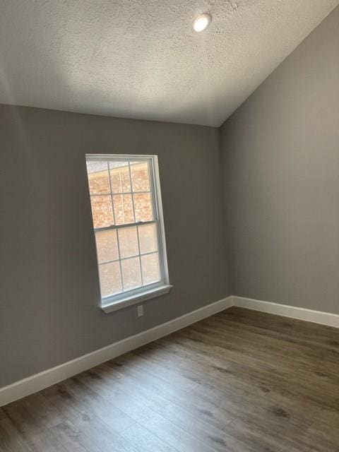 unfurnished room with recessed lighting, baseboards, a textured ceiling, and dark wood-type flooring