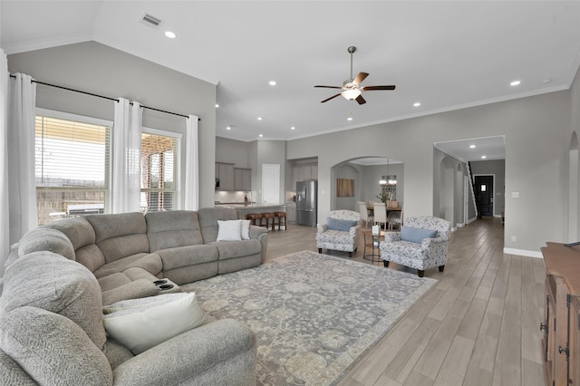 15534 Ponderosa Bend Dr, Cypress, TX 77429 - living room featuring recessed lighting, arched walkways, light wood-style floors, baseboards, and ceiling fan with notable chandelier