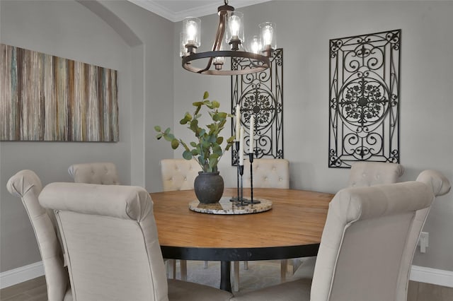15534 Ponderosa Bend Dr, Cypress, TX 77429 - dining room featuring arched walkways, baseboards, an inviting chandelier, wood finished floors, and crown molding