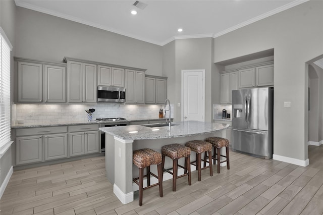 15534 Ponderosa Bend Dr, Cypress, TX 77429 - kitchen featuring gray cabinetry, stainless steel appliances, visible vents, and a sink