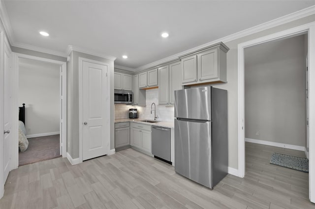 15534 Ponderosa Bend Dr, Cypress, TX 77429 - kitchen with a sink, gray cabinets, baseboards, crown molding, and appliances with stainless steel finishes