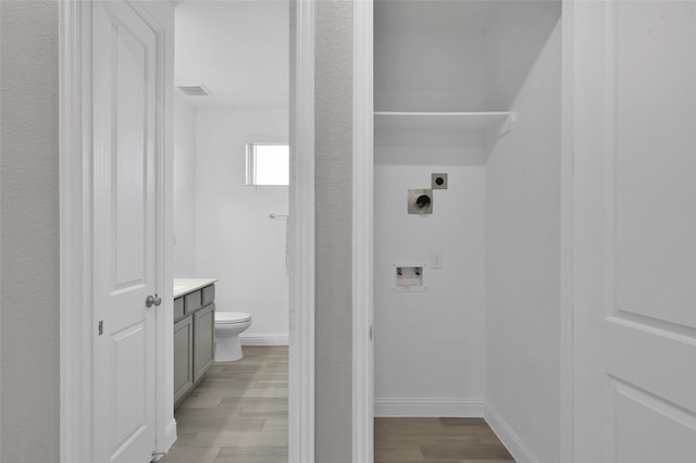15534 Ponderosa Bend Dr, Cypress, TX 77429 - bathroom with toilet, vanity, wood finished floors, and visible vents