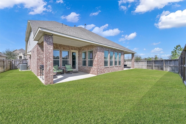 15534 Ponderosa Bend Dr, Cypress, TX 77429 - back of property with a fenced backyard, central AC unit, brick siding, a patio area, and a lawn