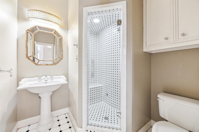 full bath with a shower stall, toilet, and baseboards