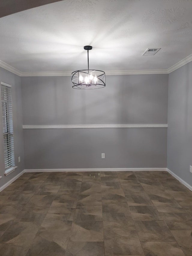 empty room featuring baseboards, visible vents, a notable chandelier, and ornamental molding
