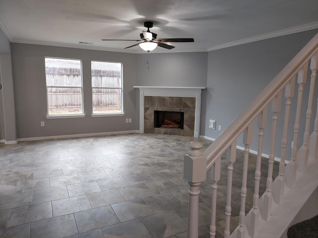 unfurnished living room featuring a ceiling fan, stairs, a tiled fireplace, ornamental molding, and visible vents