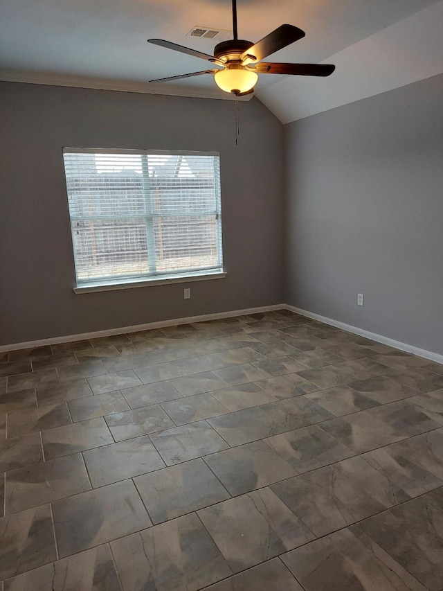 empty room featuring lofted ceiling, a healthy amount of sunlight, a ceiling fan, and visible vents
