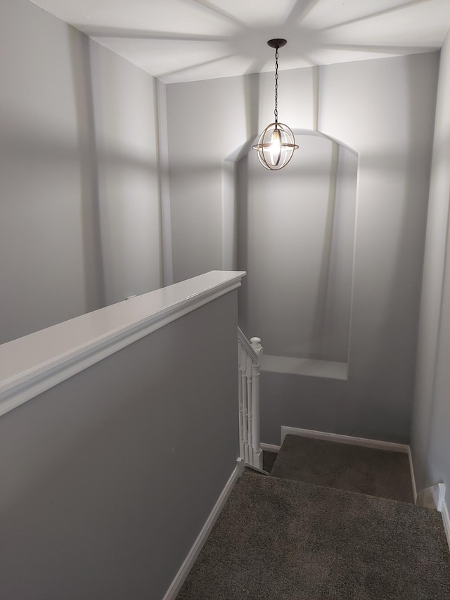 stairway featuring carpet floors and baseboards