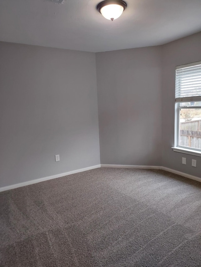empty room with carpet flooring and baseboards
